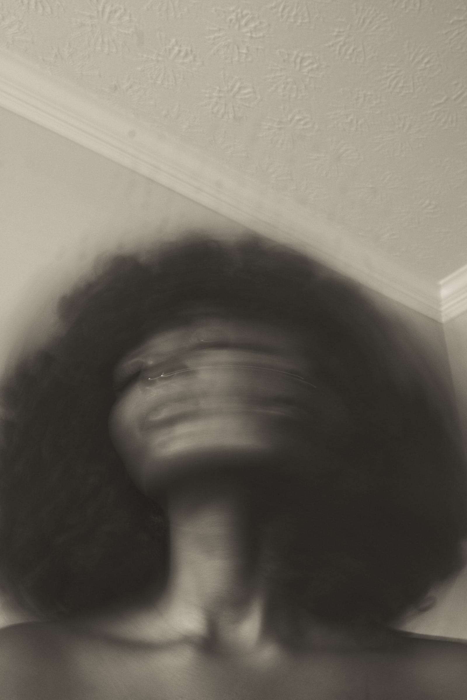 A blurred sepia portrait of a woman with a full afro, from Simi, photographed by Deun Ivory for the body