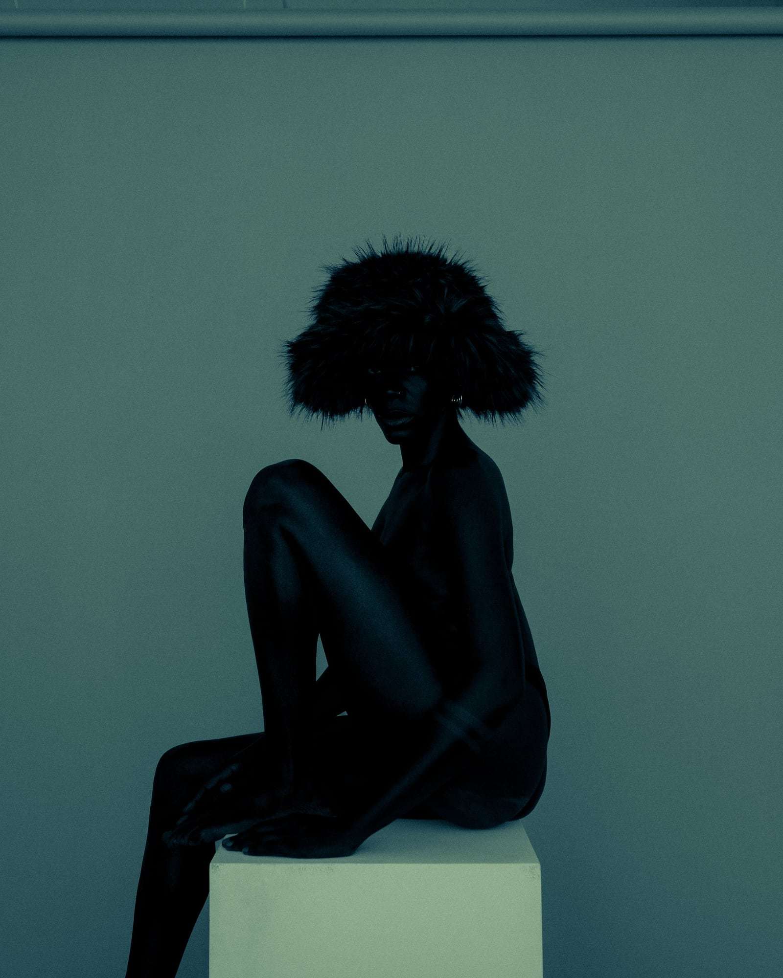 A figure in teal light, from Deun Ivory’s campaign for Youth To The People